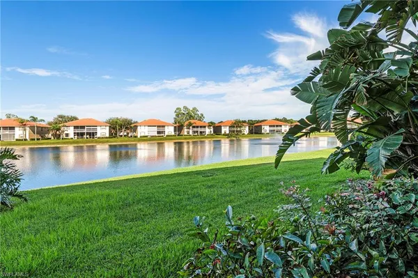 a view of a lake with houses in the back