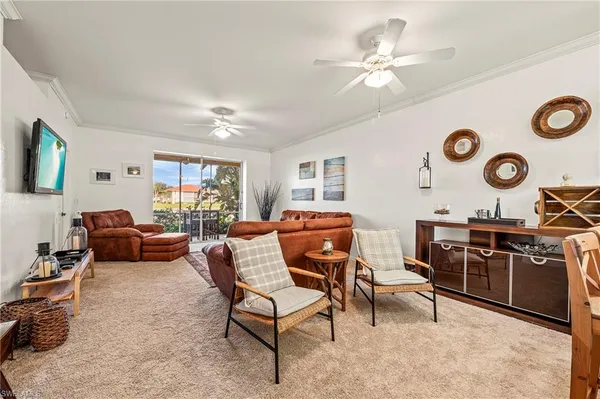 a living room with furniture and a large window with wooden floor