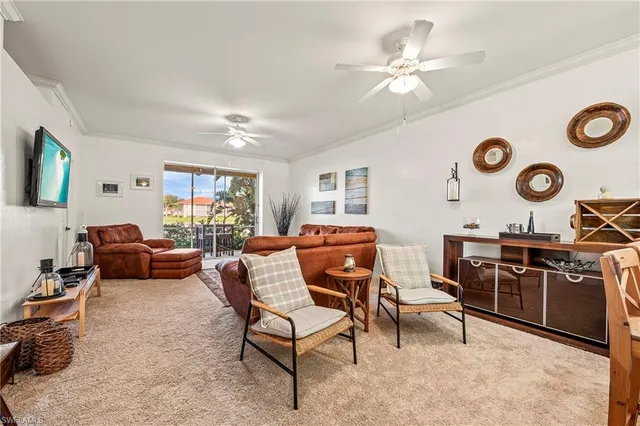 a living room with furniture and a large window with wooden floor