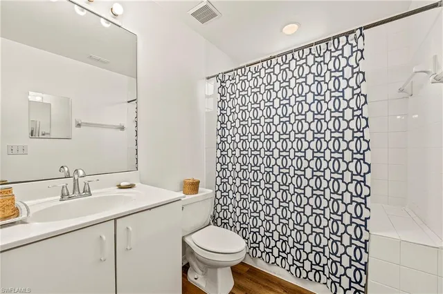 a bathroom with a sink toilet and a mirror