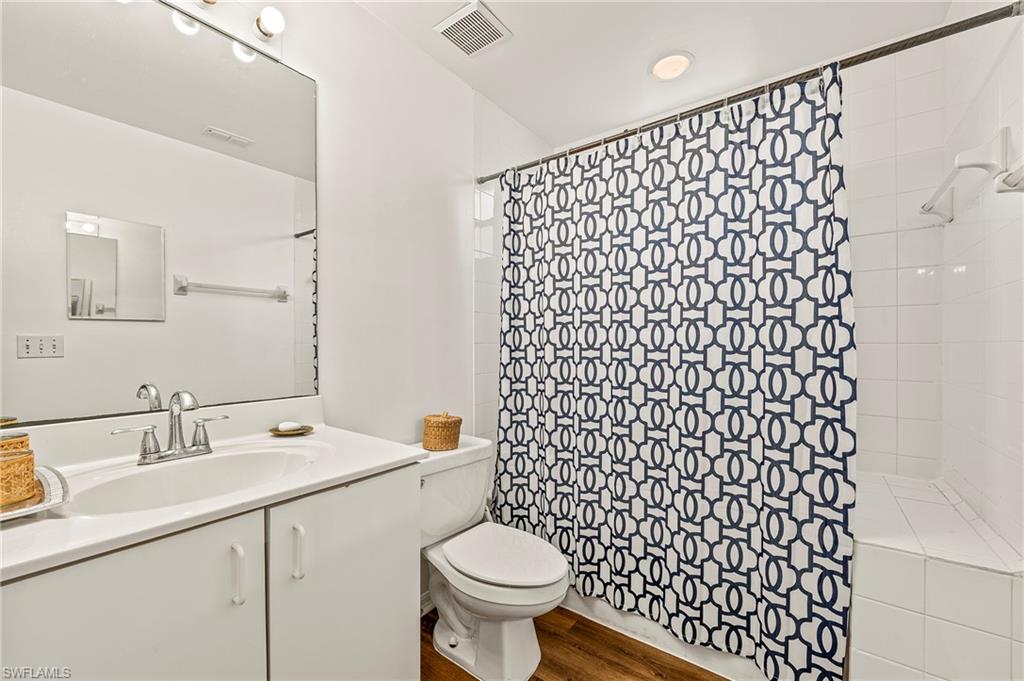 280 Robin Hood Circle, Unit 101 Naples, FL 34104 - Photo 15 of 19 a bathroom with a sink toilet and a mirror