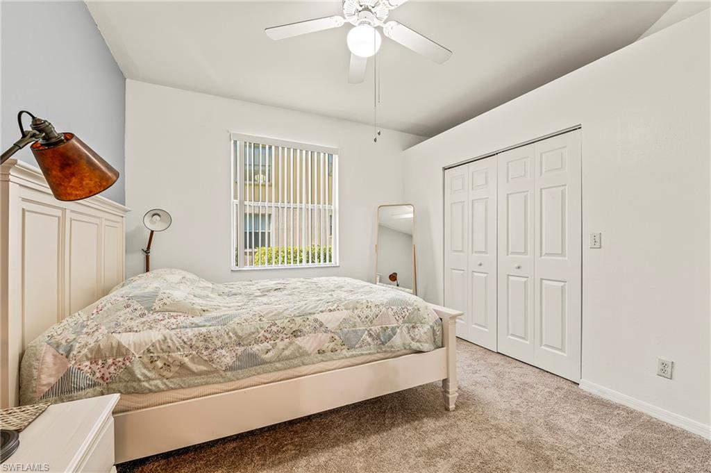 280 Robin Hood Circle, Unit 101 Naples, FL 34104 - Photo 16 of 19 a bedroom with a bed and a window