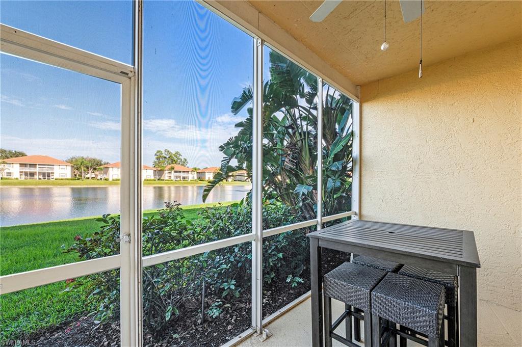 280 Robin Hood Circle, Unit 101 Naples, FL 34104 - Photo 18 of 19 a view of a room with a large window and wooden floor