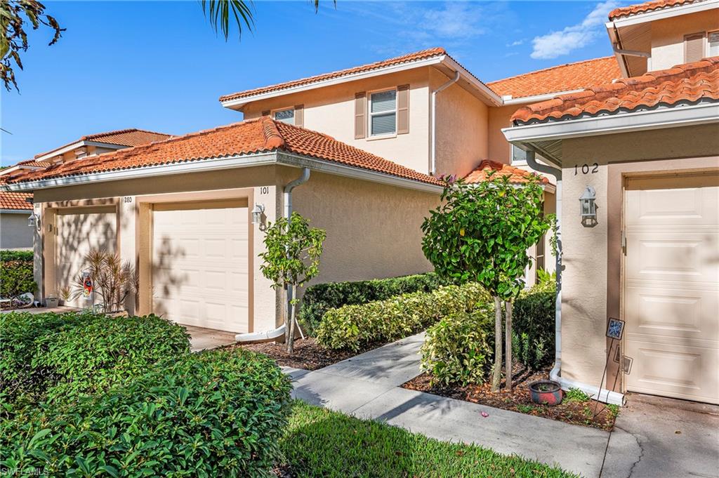 280 Robin Hood Circle, Unit 101 Naples, FL 34104 - Photo 3 of 19 a front view of a house with garden