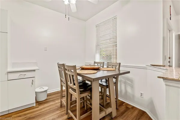 a view of a dining room with furniture and window