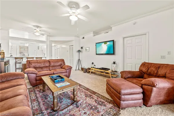 a living room with furniture a rug and a flat screen tv