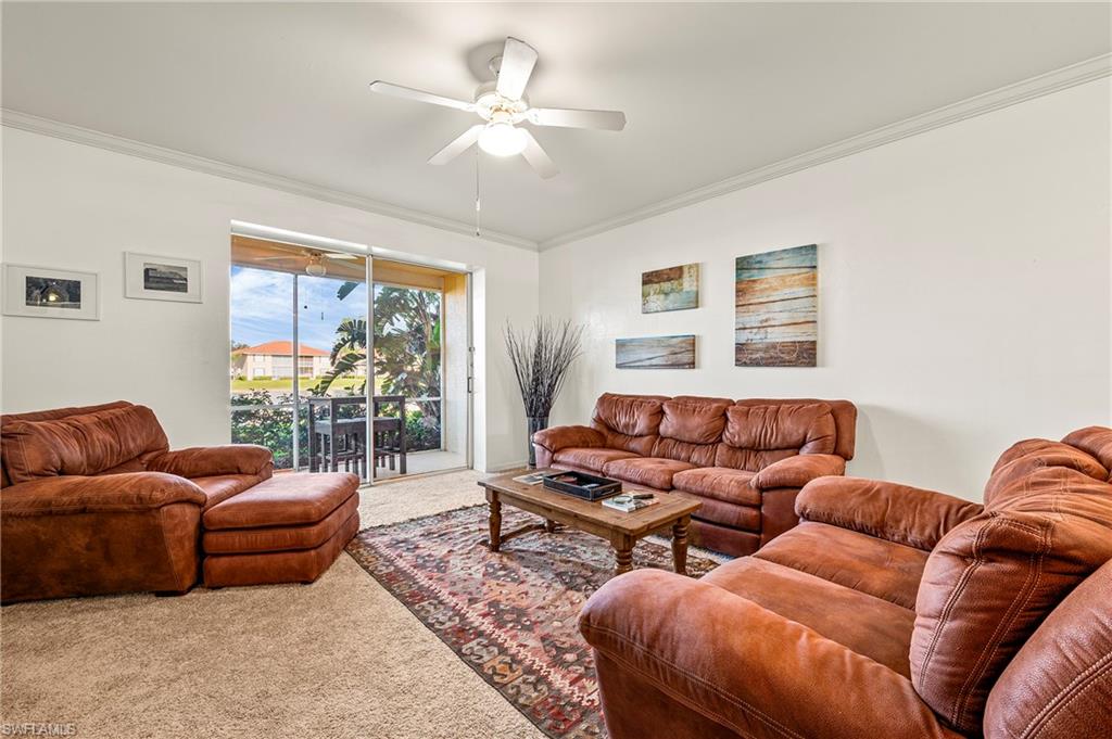 280 Robin Hood Circle, Unit 101 Naples, FL 34104 - Photo 9 of 19 a living room with furniture and a large window