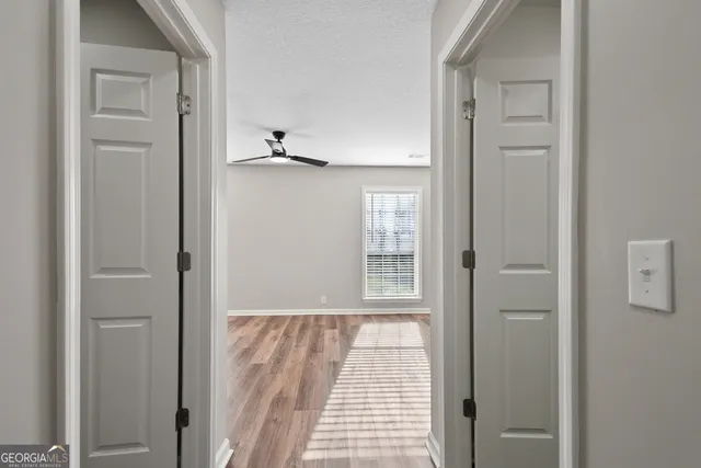 a view of a room with wooden floor cabinet and windows