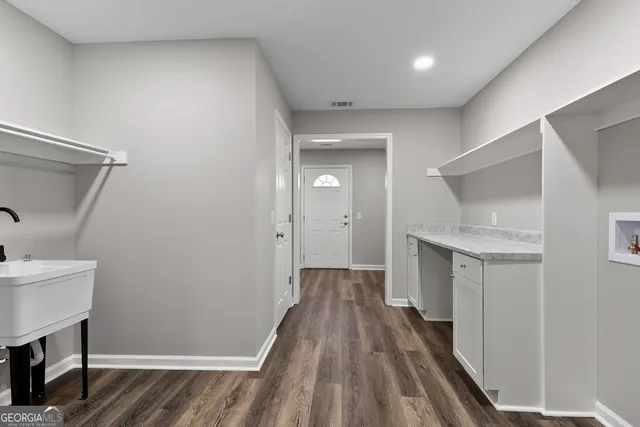 a view of hallway with wooden floor