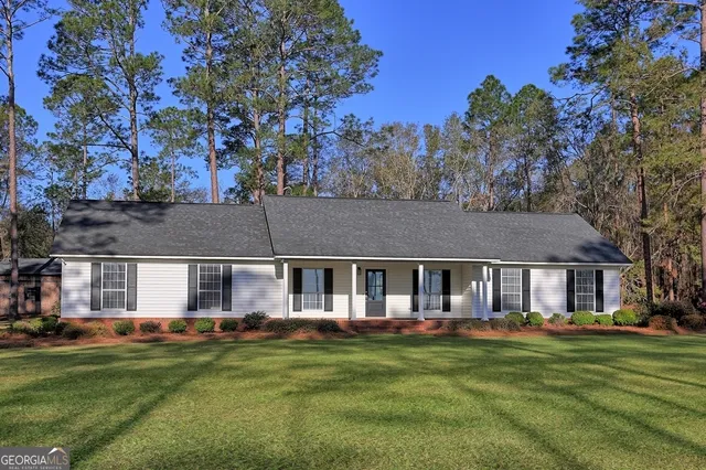 a front view of a house with a garden