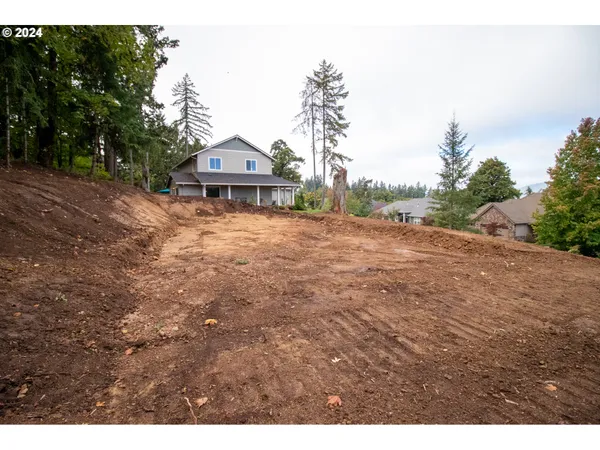 a backyard of a house with wooden floor and fence