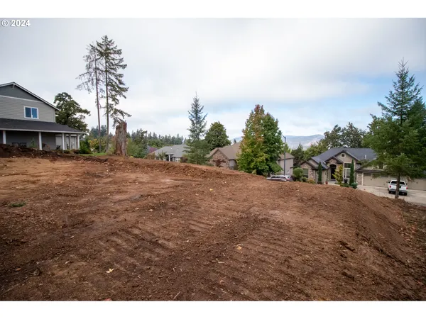 a view of a dirt road with a building in the background