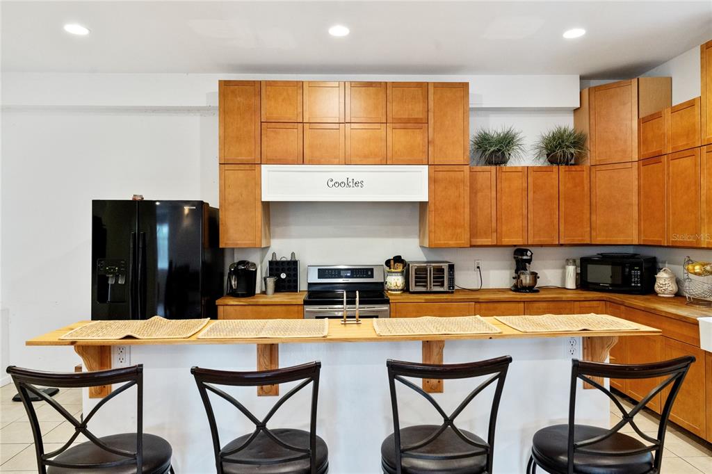 16295 Highway 40 Ocala, FL 34481 - Photo 12 of 39 a kitchen with a table chairs and a refrigerator