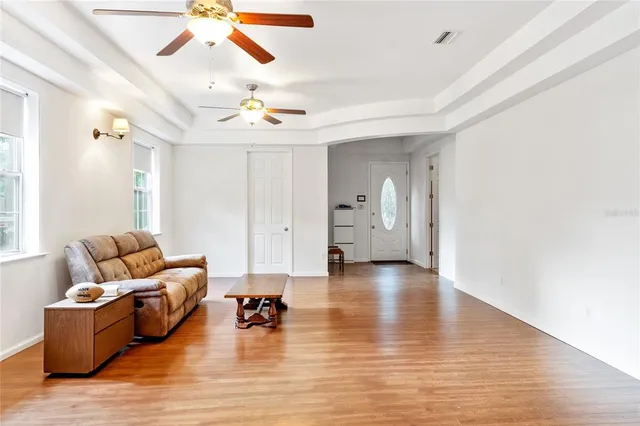 a living room with furniture and view of kitchen