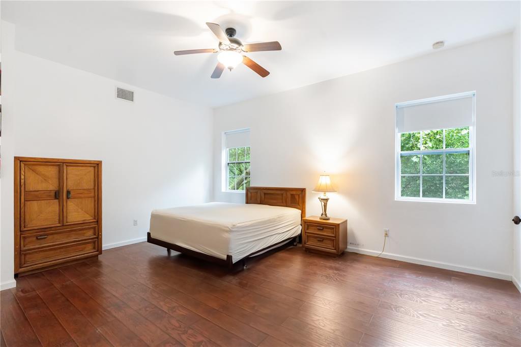 16295 Highway 40 Ocala, FL 34481 - Photo 26 of 39 a bedroom with a bed and wooden floor