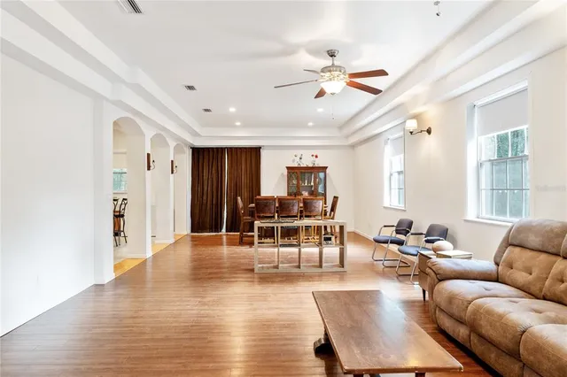 a living room with furniture and wooden floor