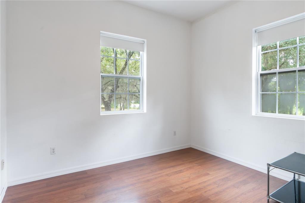 16295 Highway 40 Ocala, FL 34481 - Photo 32 of 39 an empty room with wooden floor and windows