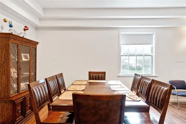 a kitchen with stainless steel appliances a stove a sink a microwave a refrigerator and white cabinets