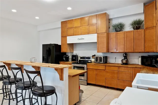 a kitchen with stainless steel appliances granite countertop a sink a stove and a refrigerator