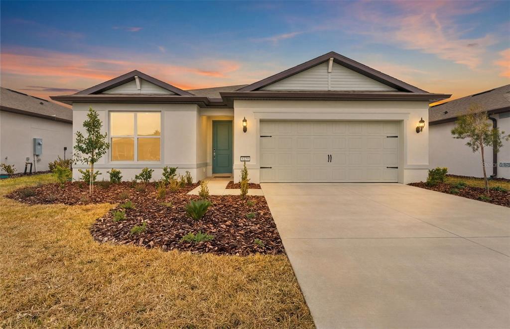 8339 Southwest 58 Loop Ocala, FL 34481 - Photo 17 of 35 a front view of a house with a yard