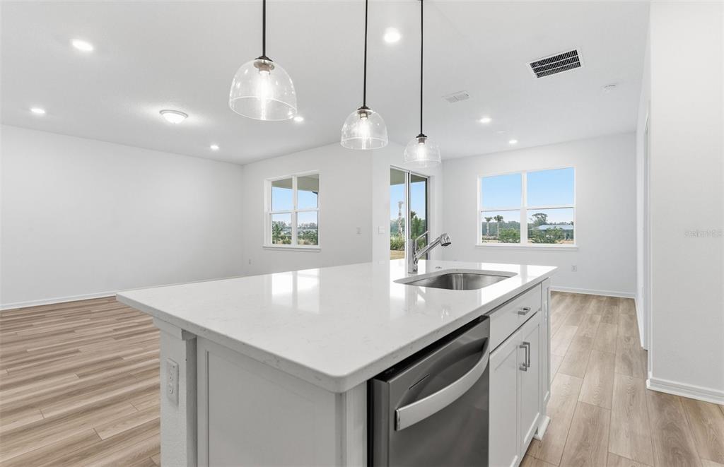8339 Southwest 58 Loop Ocala, FL 34481 - Photo 3 of 35 a kitchen with kitchen island a sink appliances and a counter space