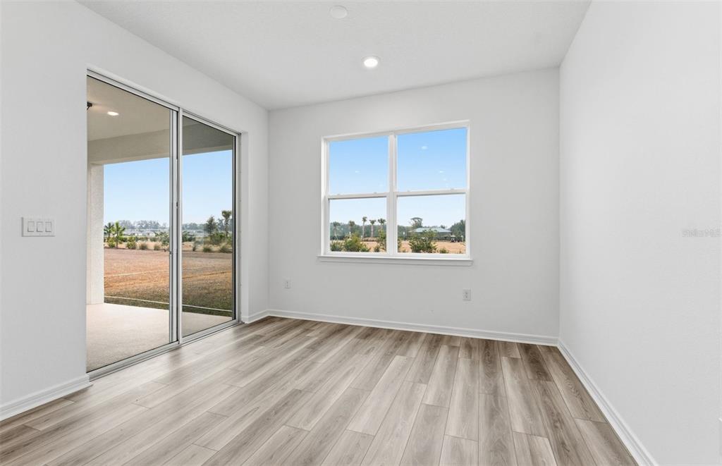 8339 Southwest 58 Loop Ocala, FL 34481 - Photo 4 of 35 wooden floor in an empty room with a window