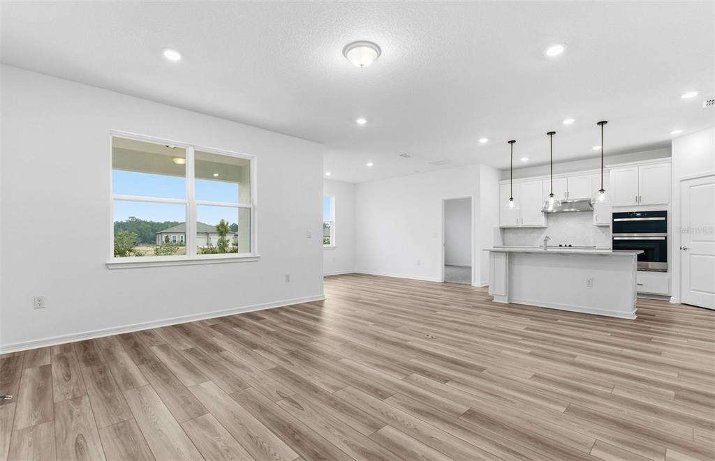 8339 Southwest 58 Loop Ocala, FL 34481 - Photo 6 of 35 a view of kitchen with kitchen island wooden floors appliances and cabinets