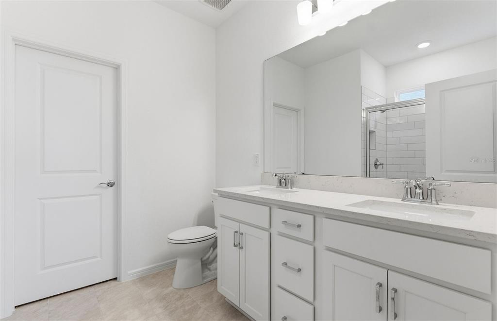 8339 Southwest 58 Loop Ocala, FL 34481 - Photo 9 of 35 a spacious bathroom with a double vanity sink toilet and a mirror