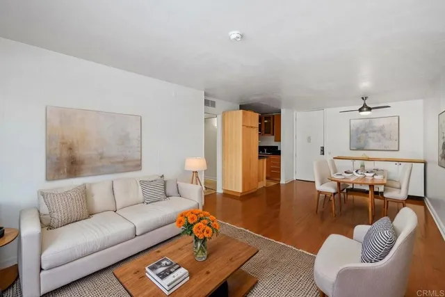 a living room with furniture wooden floor and a lamp