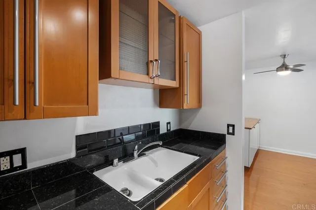 a kitchen with a sink and a stove top oven