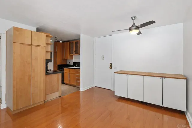 a view of a kitchen with a sink and refrigerator