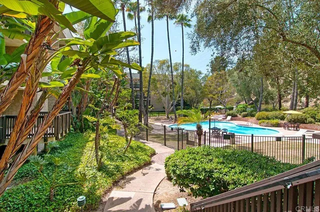 a view of a chair and tables in the backyard of a house