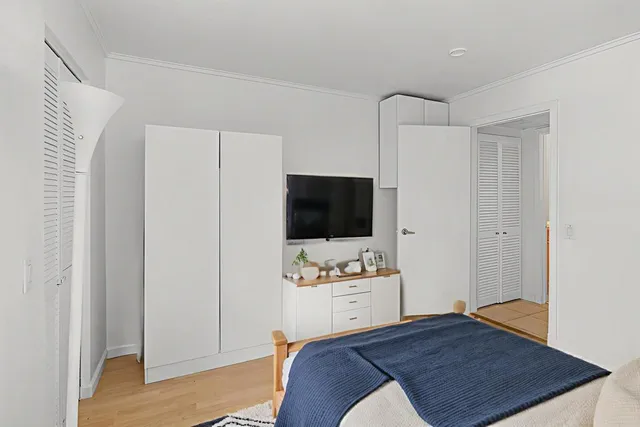 a bedroom with a bed and a flat screen tv