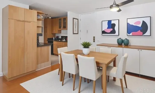 a view of a dining room with furniture and a chandelier