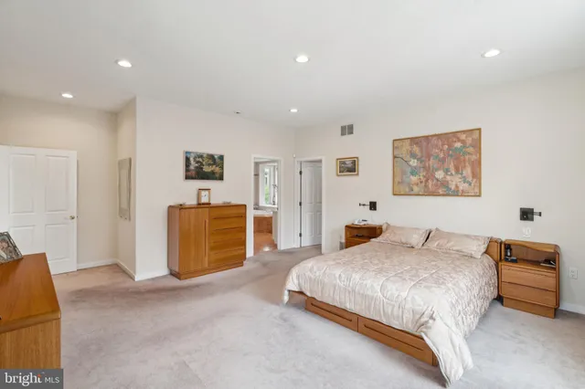 a room with stainless steel appliances lots of furniture and clutter