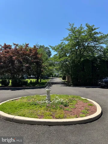 a kitchen with a stove a sink dishwasher a dining table and with wooden floor