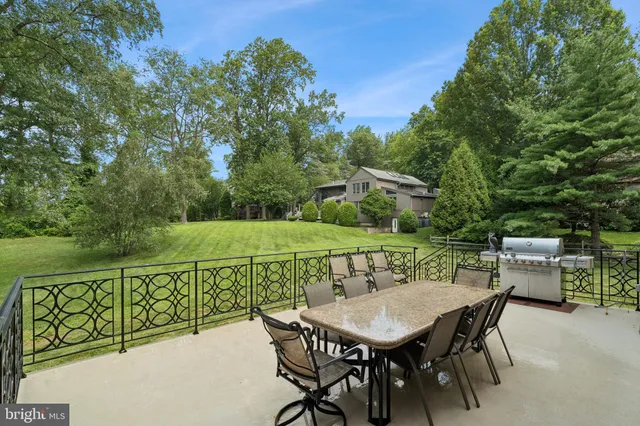 a living room with furniture a fireplace and a floor to ceiling window
