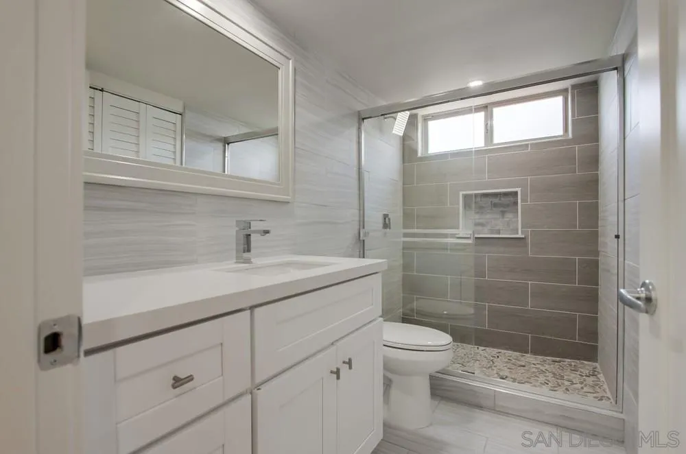 1764 Whitehall Road Encinitas, CA 92024 - Photo 13 of 25 a bathroom with a shower sink vanity mirror and toilet