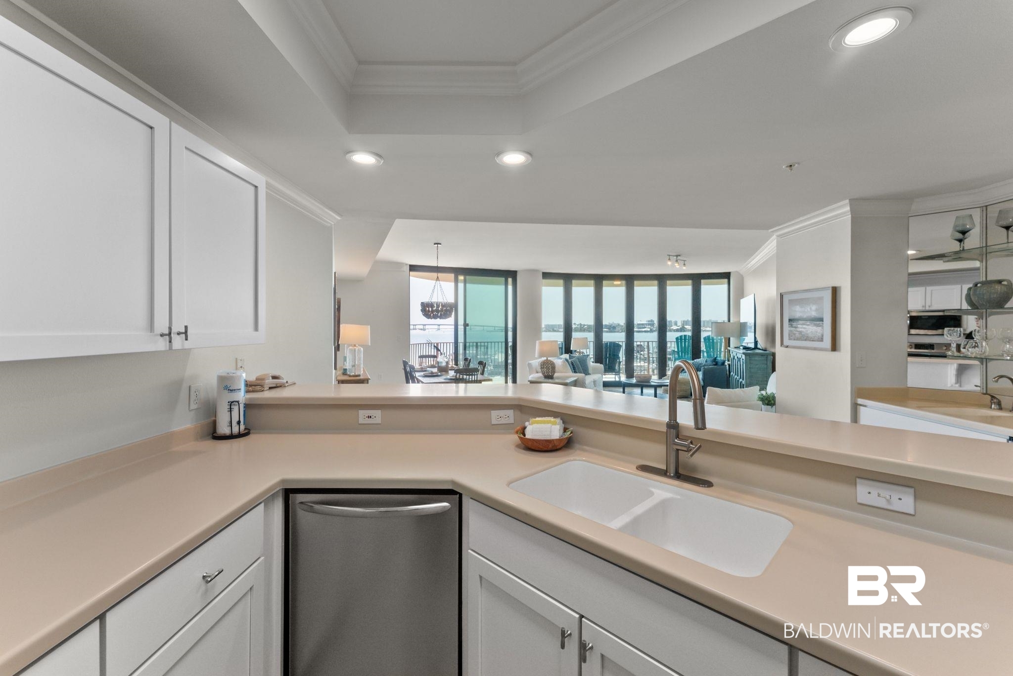 27580 Canal Road, Unit 1233 Orange Beach, AL 36561 - Photo 79 of 79 Kitchen with crown molding, light countertops, open floor plan, stainless steel appliances, and white cabinets