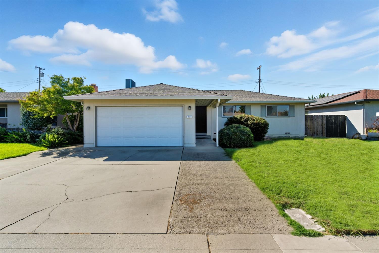 2132 Tracy Place Lodi, CA 95242 - Photo 1 of 1 a front view of a house with a yard and garage