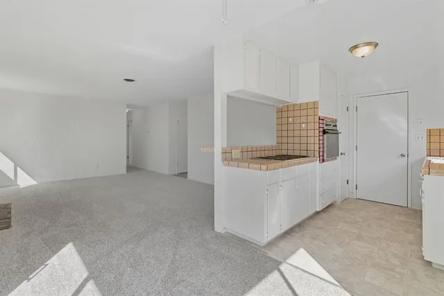 a view of kitchen with white cabinets