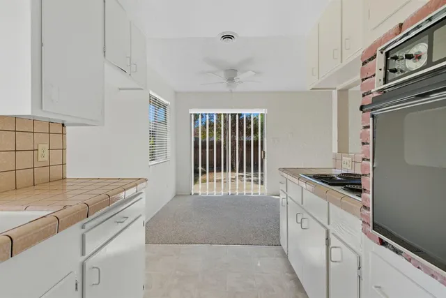 a kitchen with granite countertop a stove and a sink