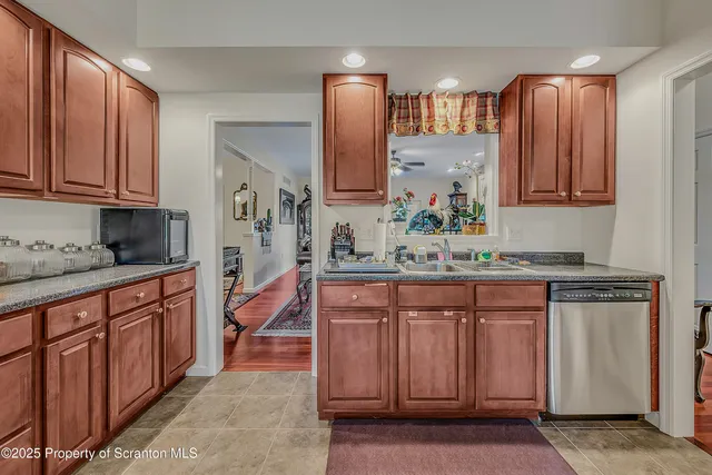 a kitchen with stainless steel appliances granite countertop a sink and cabinets