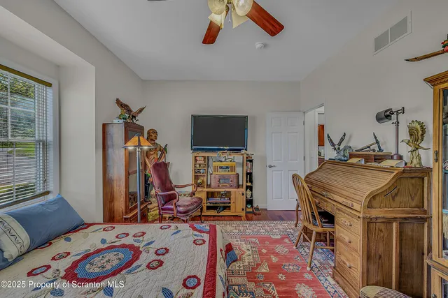 a bedroom that has a bed and a tv in it