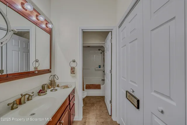 a bathroom with a sink a mirror and a shower