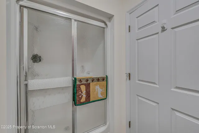 a bathroom with a glass shower door