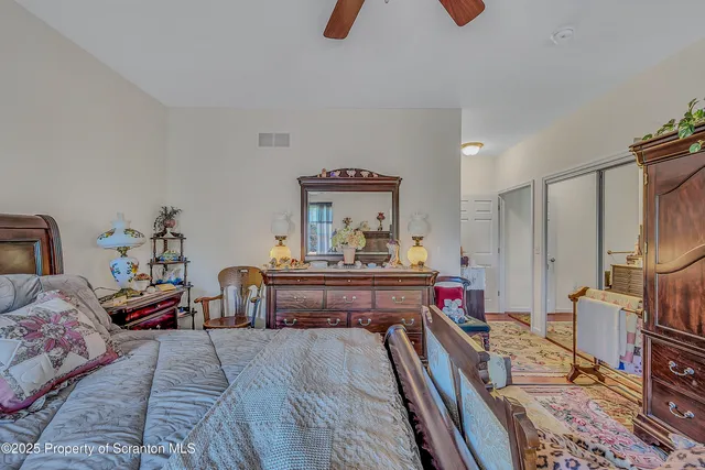 a bedroom with furniture and a flat screen tv
