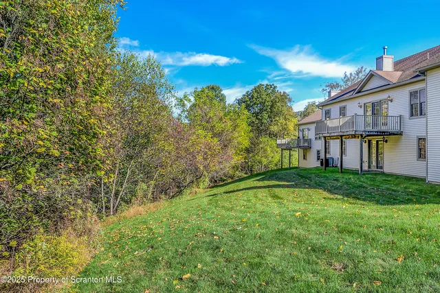 a backyard of a house with lots of green space