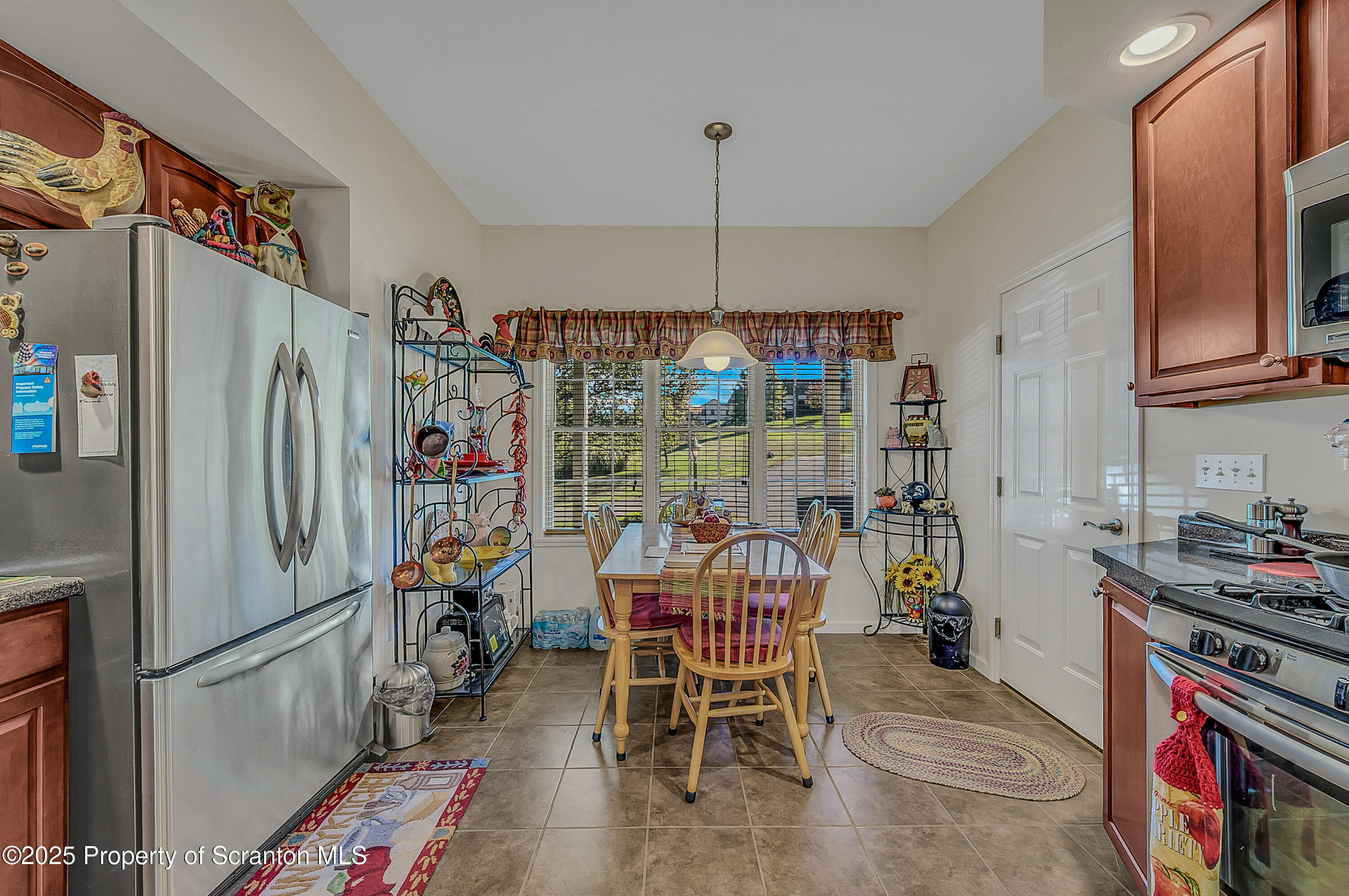 148 Grandview Drive Tunkhannock, PA 18657 - Photo 9 of 41 a kitchen with stainless steel appliances granite countertop a refrigerator and a wooden cabinets