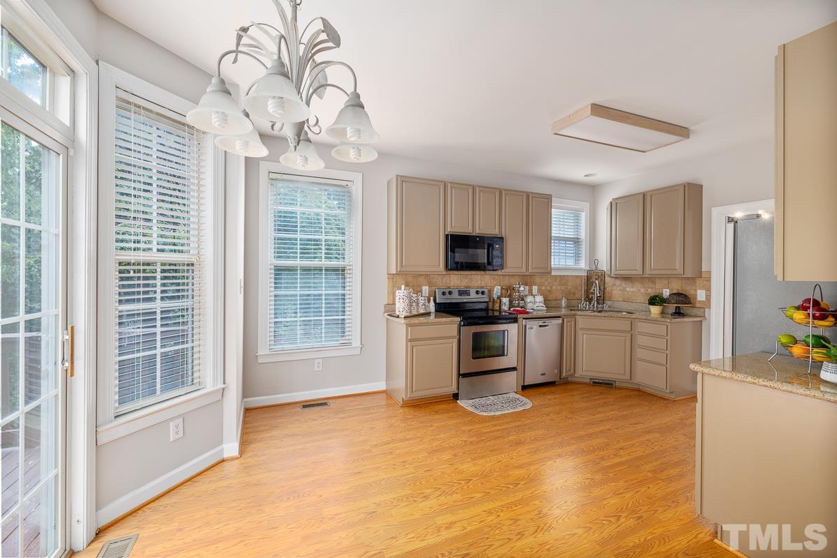 3308 Heygill Lane Raleigh, NC 27604 - Photo 17 of 18 a kitchen with white cabinets and appliances